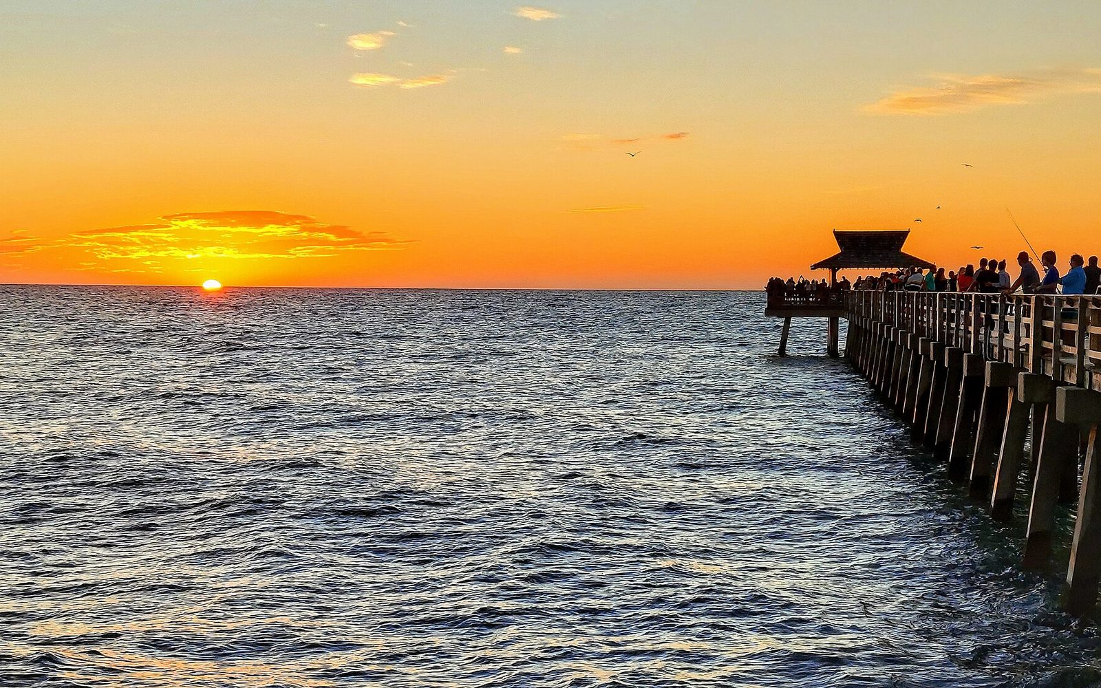 Naples Pier reaching into the Gulf at sunset